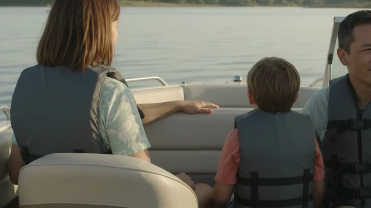 A family wearing life jackets aboard a recreational boat on a calm Texas lake